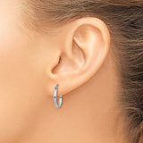 15 mm slim huggie hoop earrings in solid 14K white gold shown on ear