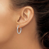 20 mm slim huggie hoop earrings in solid 14K white gold shown on ear