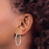 30 mm slim hoop earrings in solid 14K white gold shown on ear