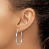 35 mm slim hoop earrings in solid 14K white gold shown on ear