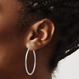 40 mm slim hoop earrings in solid 14K white gold shown on ear