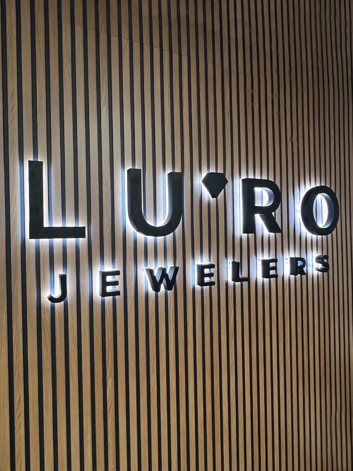 Illuminated logo sign inside the showroom at Lu’Ro Jewelers