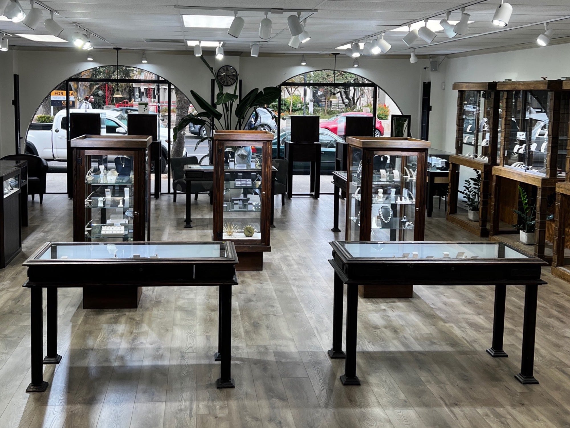 Jewelry showroom view with glass display cases and natural light at Lu’Ro Jewelers